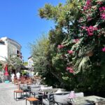 Alacati street with tables and blooming vines (Photo: Christine Sarkis)