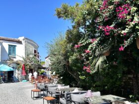 Alacati street with tables and blooming vines (Photo: Christine Sarkis)