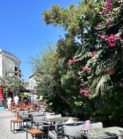 Alacati street with tables and blooming vines (Photo: Christine Sarkis)