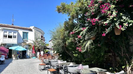 Alacati street with tables and blooming vines (Photo: Christine Sarkis)
