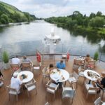 Viking longship sailing down a river in Europe