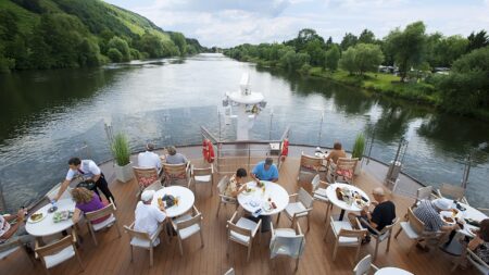 Viking longship sailing down a river in Europe