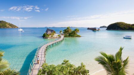Likuliku Lagoon Resort aerial view of long pier to overwater bungalow