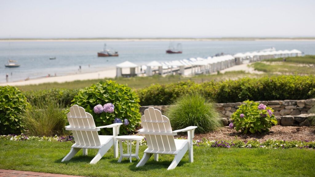 Two adirondak chairs overlooking the beach at Chatham Bars Inn