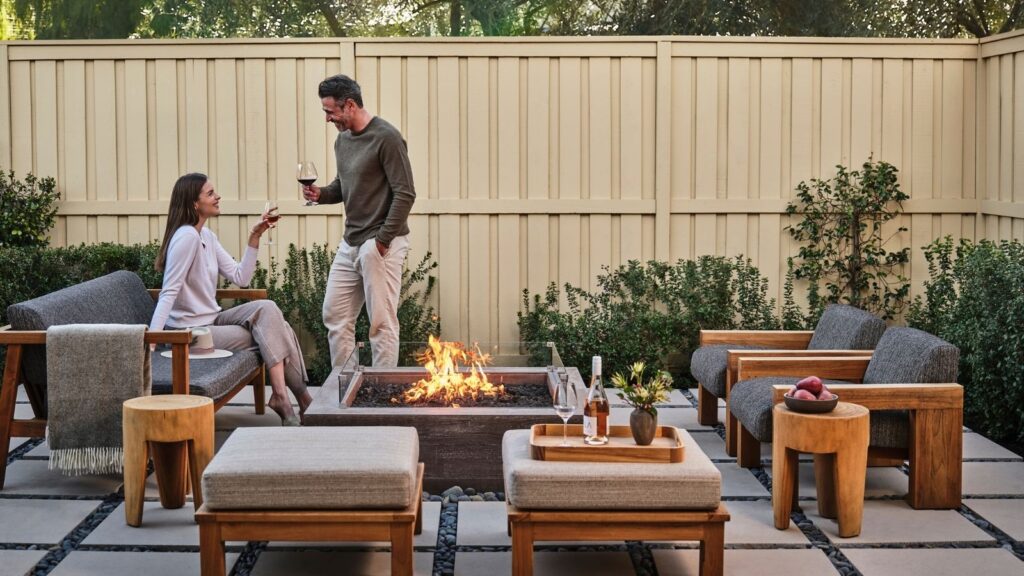 Couple on a patio next to a firepit in a suite at Solage in the Napa Valley