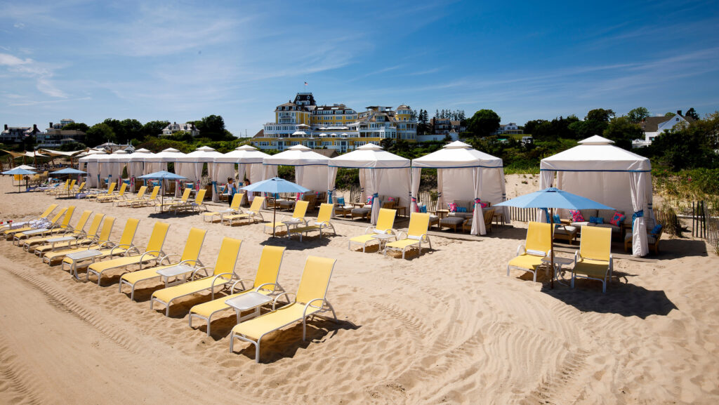 Yellow lounge chairs and cabanas on the beach at Ocean House