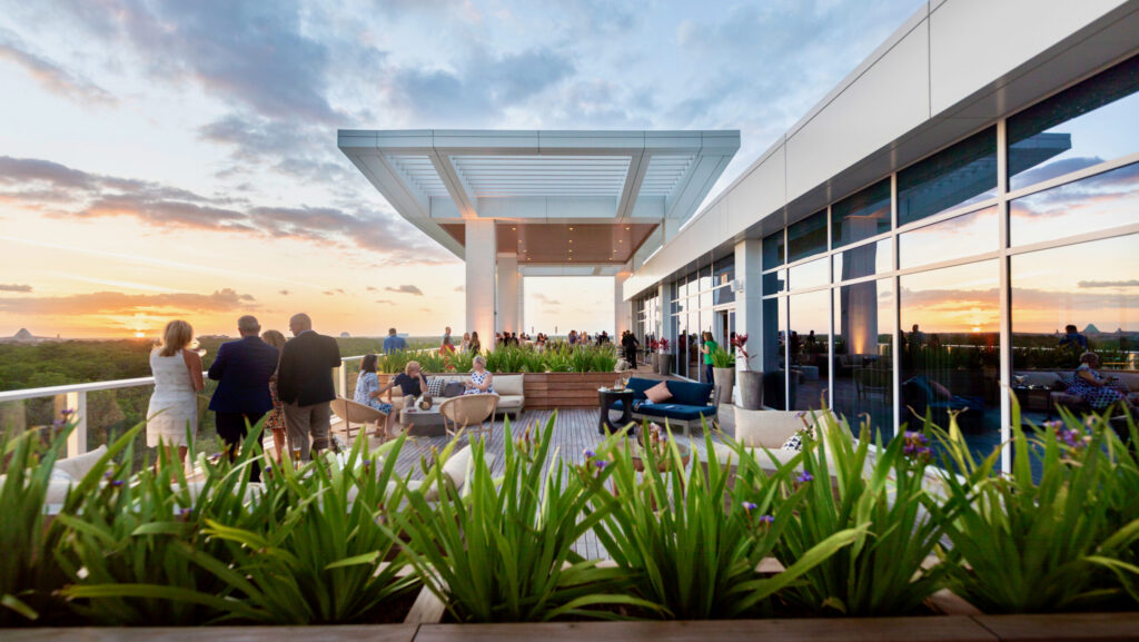 Outdoor deck with people enjoying the sunset