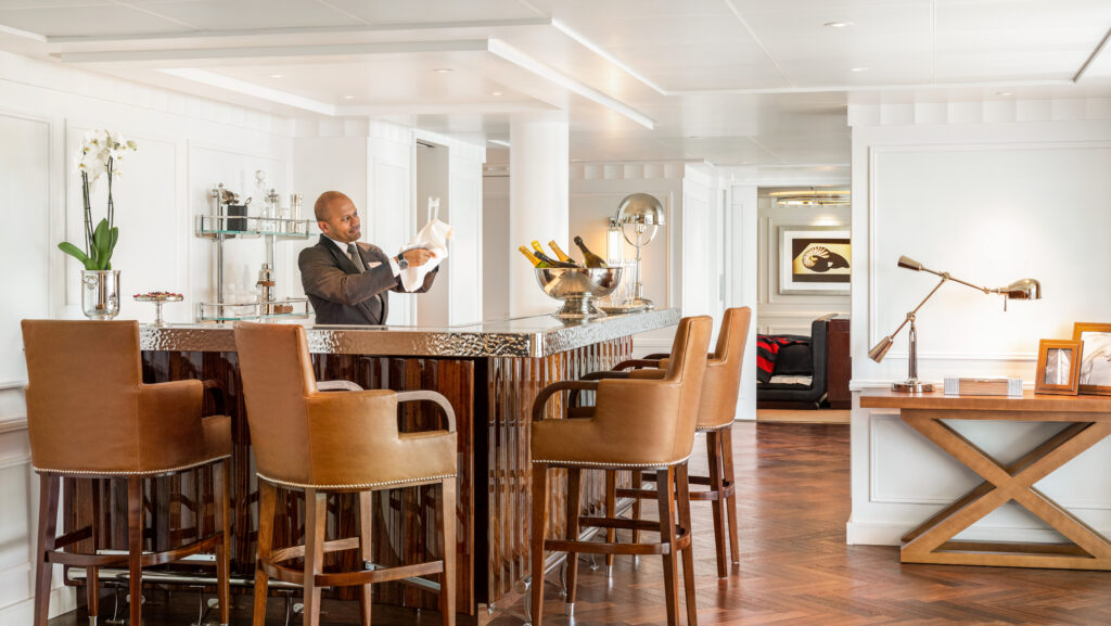 Butler pouring wine on Oceania Allura