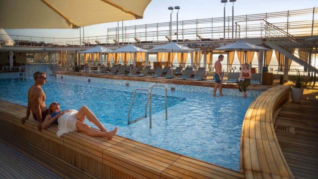 Couples lounging by the cruise ship pool.