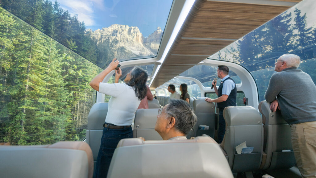 People on a glass-domed train