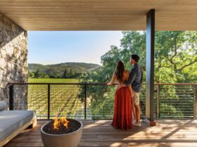 A couple on a balcony overlooking at vineyard at Alila Napa Valley