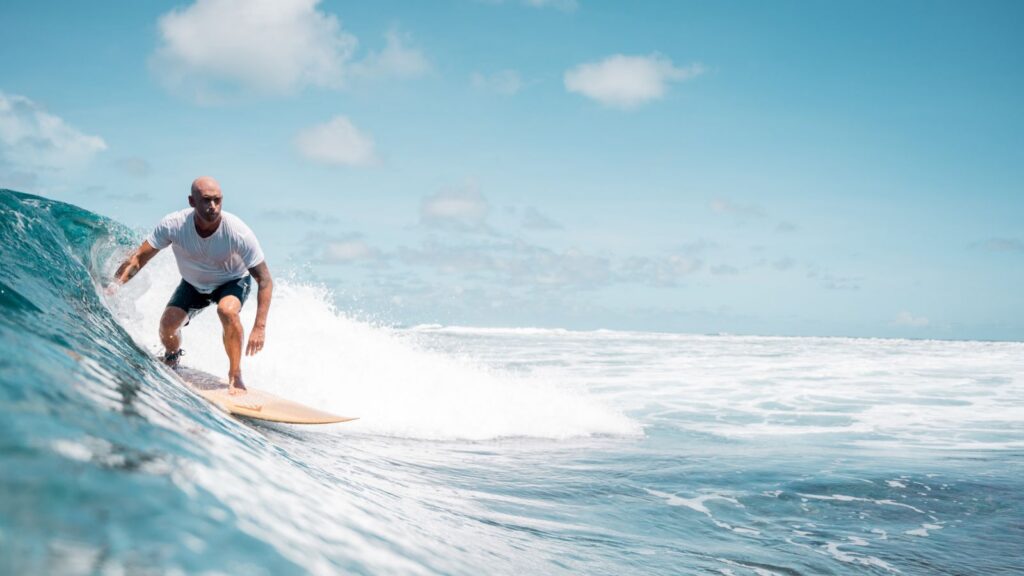 surfer on wave at Four Seasons Resort Seychelles at Desroches Island