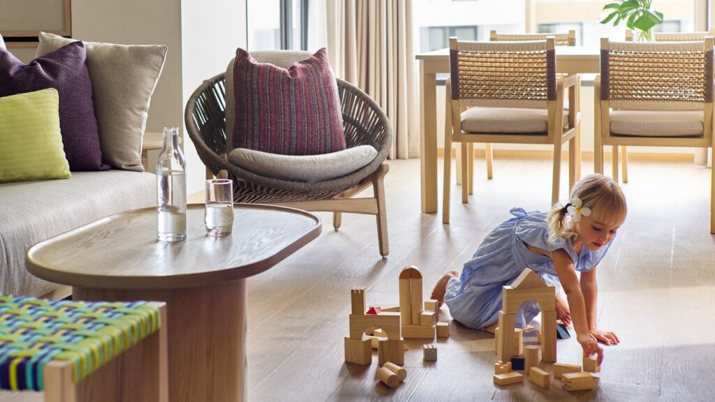 A child playing in a guest room at Chatrium Phuket Rawai
