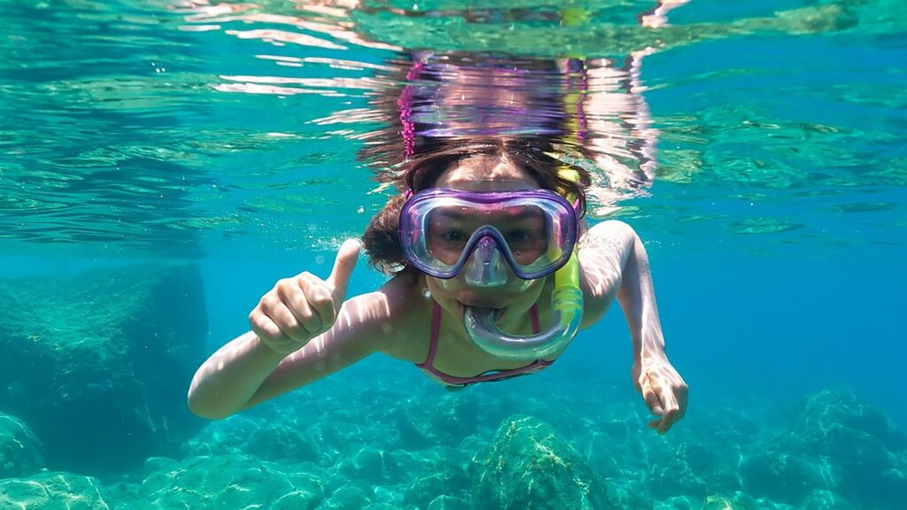 A child snorkeling at Domes Lake Algarve