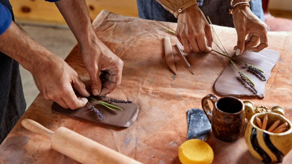 Close-up of hands in the Pressed Flower Pottery class Wildflower Farms